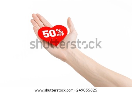 Valentine's Day discounts topic: Hand holding a card in the form of a red heart with a discount of 50% on an isolated white background in studio