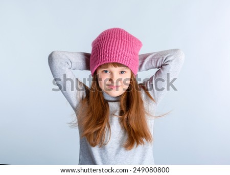  adorable smiling child girl wearing pink knitted hat