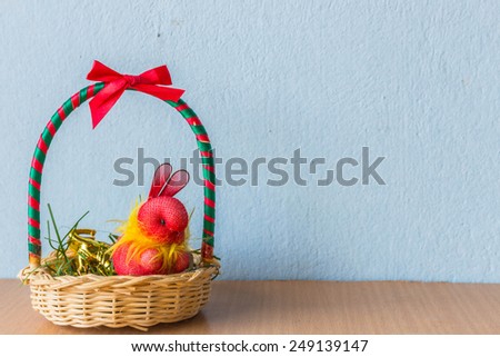 Rabbit in the gift basket on the table.