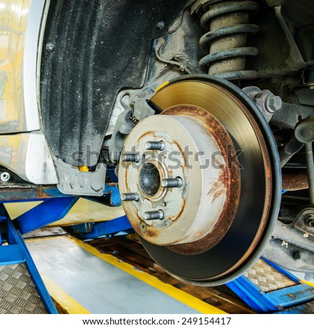 Close up of disk brake on car in process of damaged.- Brake job 
