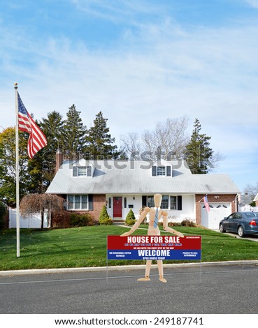 American flag pole mannequin holding Real estate for sale open house welcome sign suburban cape cod style home autumn blue sky clouds day residential neighborhood USA