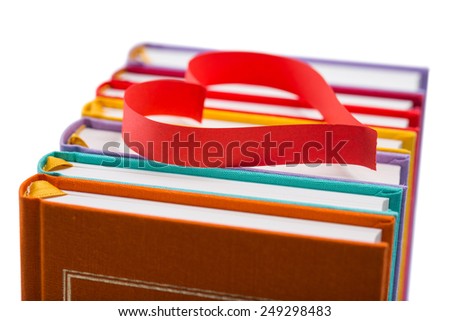 new books in colorful hard cover and paper tape in the shape of heart isolated on white background isolated on white background