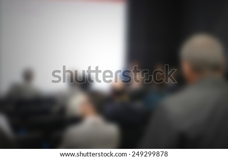 People at trade show. Intentionally blurred post production, humans and location not recognizable.