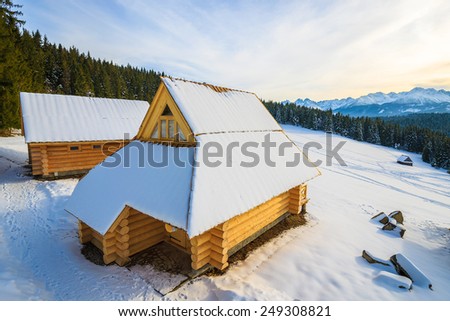 Wooden houses in Bukowina Tatrzanska in winter landscape of Tatra Mountains, Poland