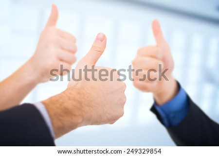 Businessmen gesturing thumbs up. Business concept.