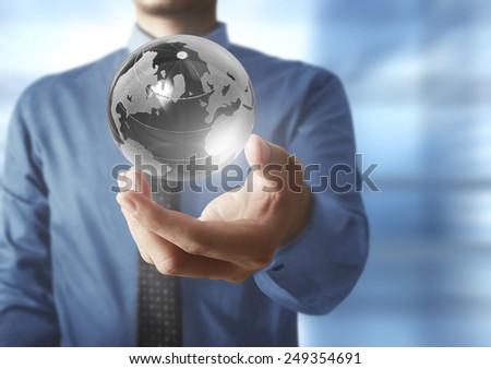 holding a glowing earth globe in his hands. Earth image provided by Nasa 
