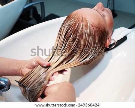 Hair care in modern spa salon Royalty-Free Stock Photo #249360424