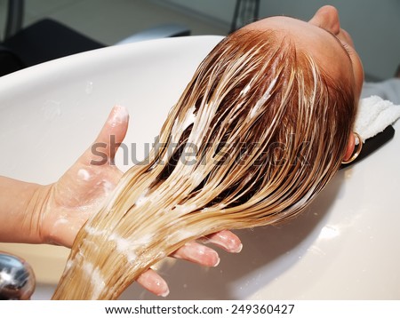 Hair care in modern spa salon Royalty-Free Stock Photo #249360427