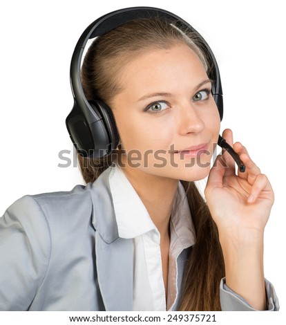 Businesswoman in headset, with her fingers on microphone boom, looking at camera. Isolated over white background