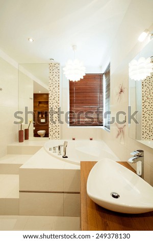 Photo of bright modern bathroom full of luxury