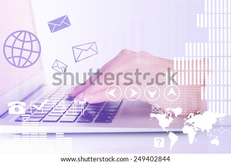 Businesswoman using laptop with digital layer effect on background