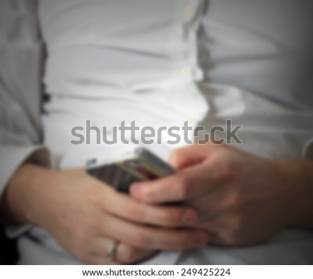 Man and his smart phone. Intentionally blurred post production.