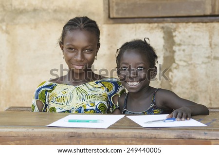 Two African Ethnicity Children Smiling Studying in a School Environment (Schooling Education Symbol) Royalty-Free Stock Photo #249440005