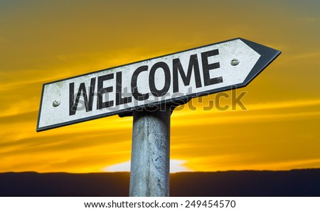 Welcome sign with a sunset background