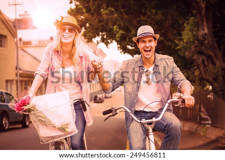 Hip young couple going for a bike ride on a sunny day in the city