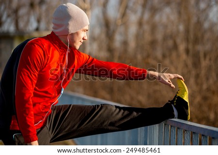 Athlete stretching out before jogging Royalty-Free Stock Photo #249485461