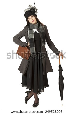 Young woman in the role of Mary Poppins in front of white background  Royalty-Free Stock Photo #249538003