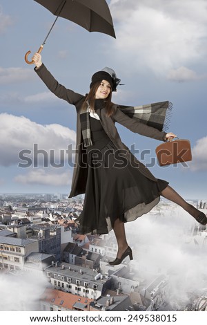 Young woman flies on an umbrella like Mary Poppins  Royalty-Free Stock Photo #249538015