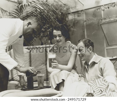 Couple served beer in a 1933 advertising photo for a brewer.