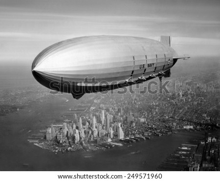 USS Macon, sister ship of USS Akron, over New York Harbor, ca. 1933. USS Macon, participated in Naval operations until crashing in a storm off Point Sur, California, on Feb. 12, 1935. Royalty-Free Stock Photo #249571960