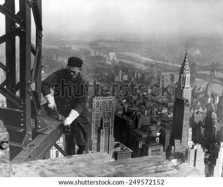 Middle aged iron worker at the Empire State Building construction site, 1930. The Chrysler Building's spire is at right. Photo By Lewis Hine. Royalty-Free Stock Photo #249572152