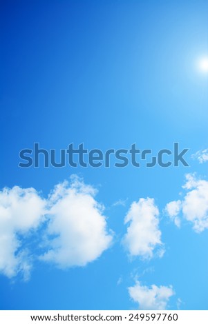blue sky with white, soft clouds under the sun