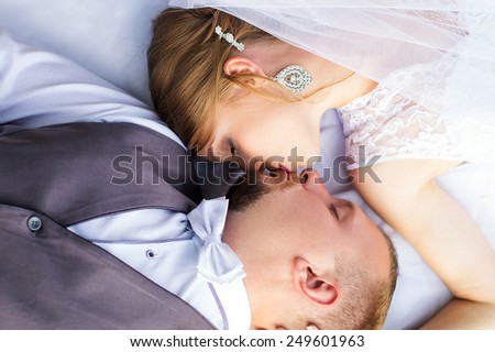 Wedding, happy bride and groom kissing on top view