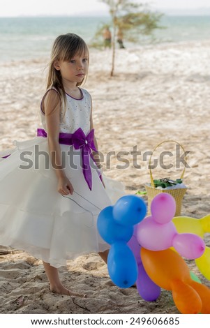 Cute little girl playing at the beach