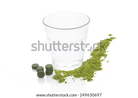 Spirulina, chlorella and young barley as ground powder and effervescent tablet isolated on white background. Detox and detoxify.