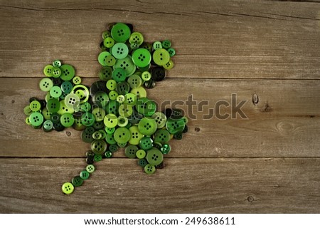 St Patricks Day shamrock made of buttons against an old wood background
