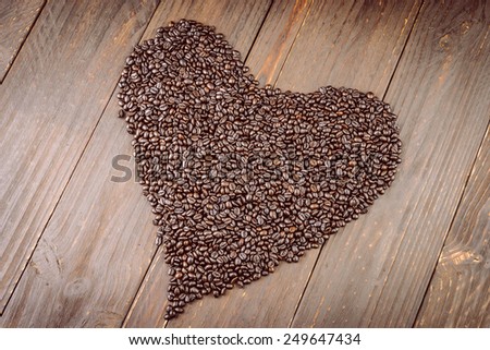 Heart coffee beans on wooden background - vintage effect style pictures