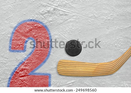 Hockey stick, puck and the numeral two painted on the ice