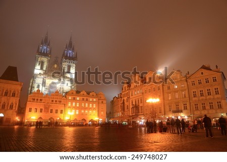 Main square of the Prague Old Town and distant Church of Our Lady before Tyn in foggy autumn night, Czech Republic
