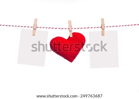 Blank instant photo and red paper heart hanging on the clothesline. Isolated on white.