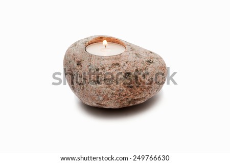 Candle in stone on a white background