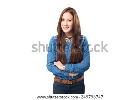 Trendy young woman looking happy with her arms crossed. Over white background