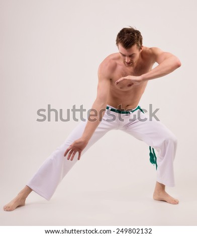 Capoeira dancer on white background