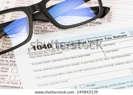 Tax form with glasses  taxation concept