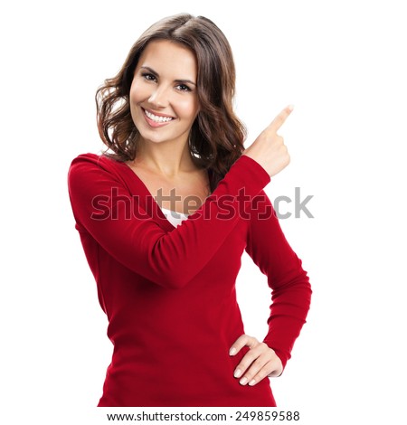 Portrait of cheerful young woman showing copyspace, visual imaginary or something, or pressing virual button, isolated over white background