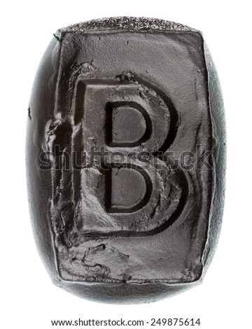 Handmade ceramic letter B painted in black isolated on white