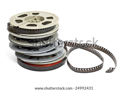still life of dirty, old 8mm cine film and reels; isolated on white ground