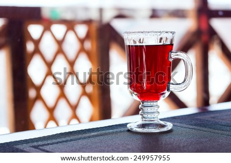 Mulled wine in a glass with sugar on the top