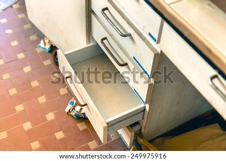 Cupboard with opened empty drawer closeup photo Royalty-Free Stock Photo #249975916