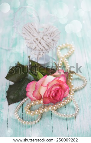 Background with fresh flower and heart. Rose on  wooden table. Selective focus.