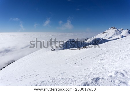 View on mountains and blue sky above clouds, Krasnaya Polyana, Sochi, Russia