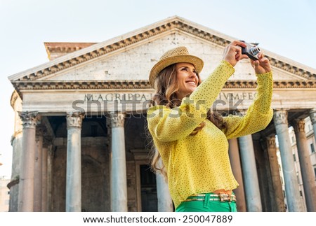 Happy young woman taking photo in front of pantheon in rome, italy