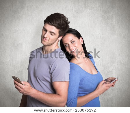 Young couple sending a text against weathered surface