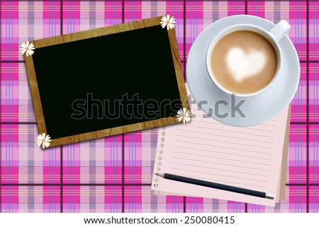    blank board and coffee cup on pink fabric  background.