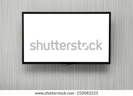 Blank lcd TV hanging at the wall with copy space and clipping path for the screen Royalty-Free Stock Photo #250083223