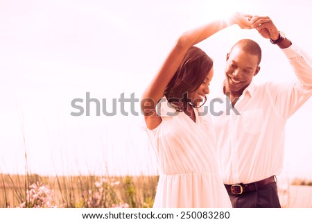 Romantic couple dancing and smiling outside in the garden